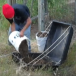 Pouring dirt into a plastic container