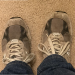 Feet wearing 2 left shoes